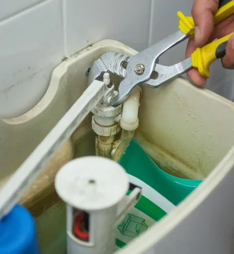 close-up-hand-repairing-toilet copy