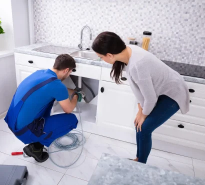 male-plumber-cleaning-clogged-sink-pipe-with-drained-cable copy